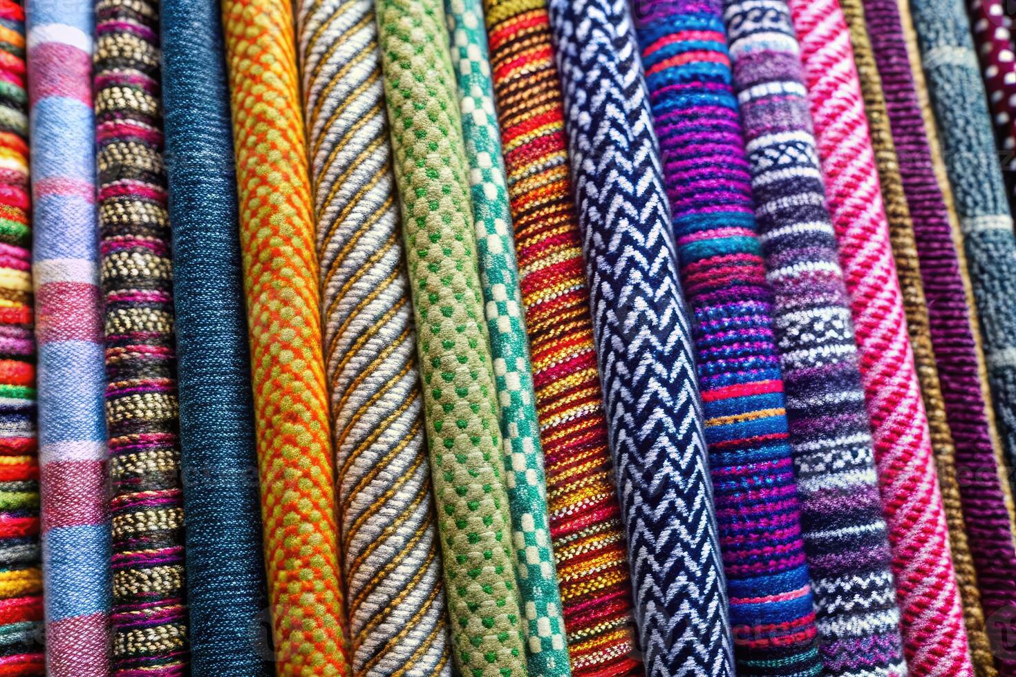 Colorful woven textiles with various patterns and textures. photo
