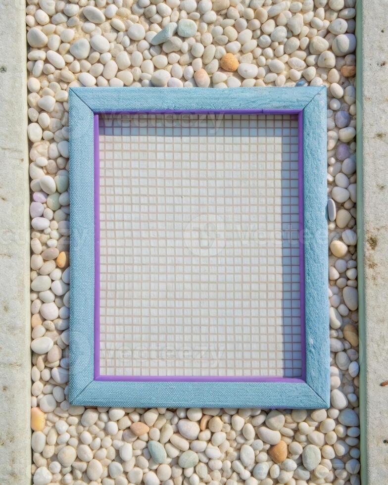 Decorative frame on gravel with textured blue fabric as a backdrop photo