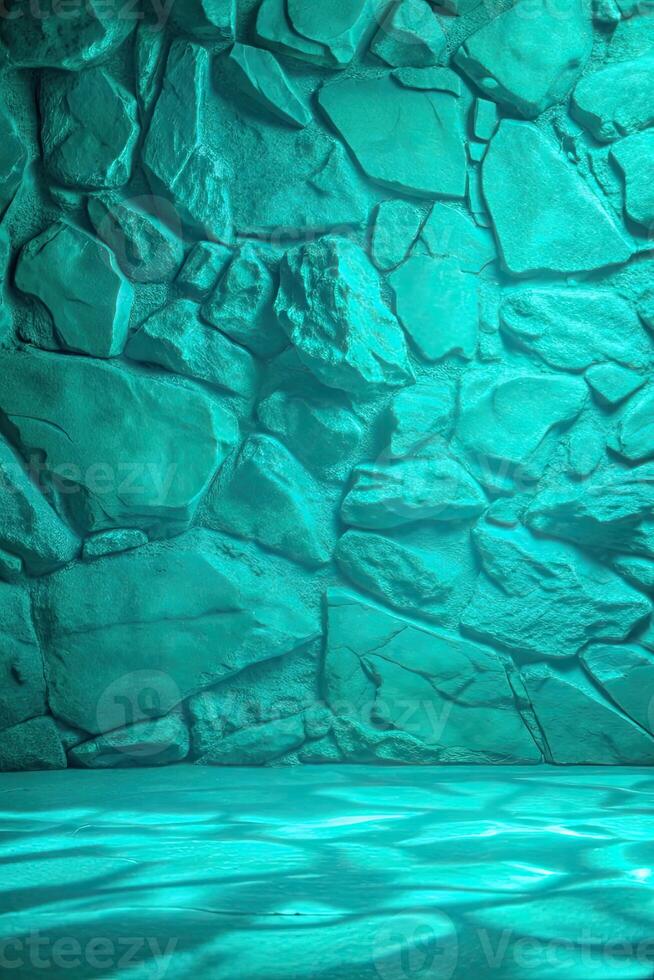 Turquoise stone wall with a textured surface. photo