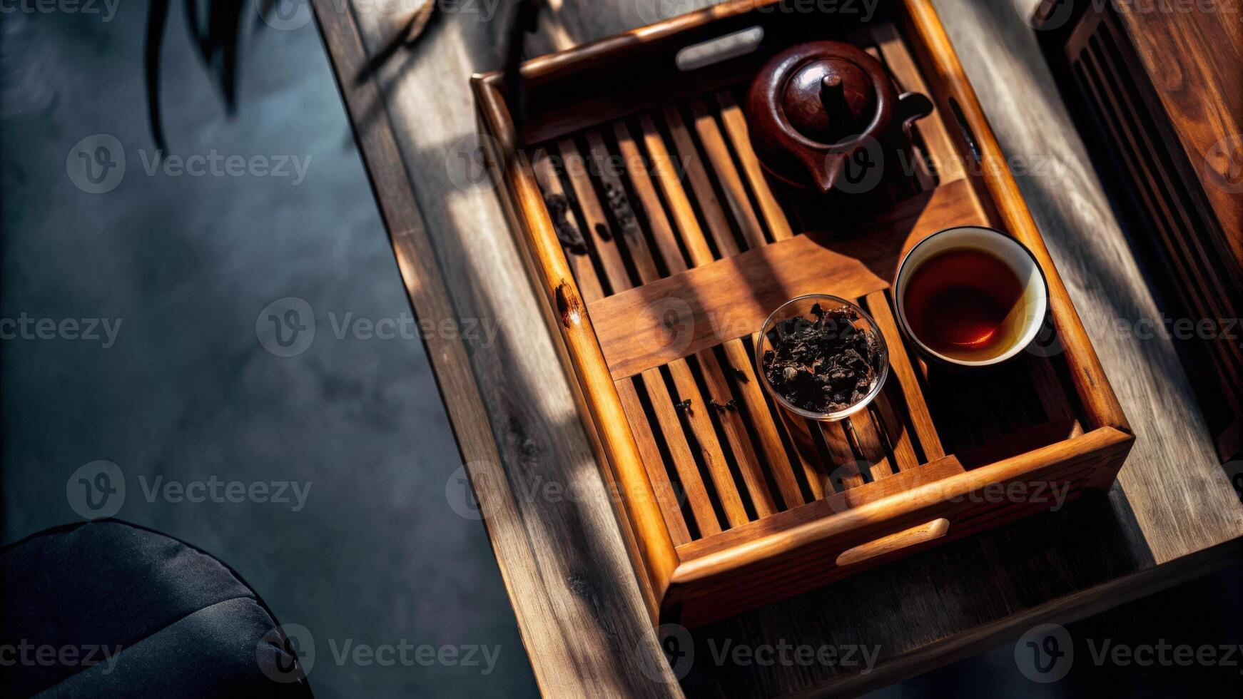 Traditional Tea Set on Wooden Tray with Brewing Leaves photo
