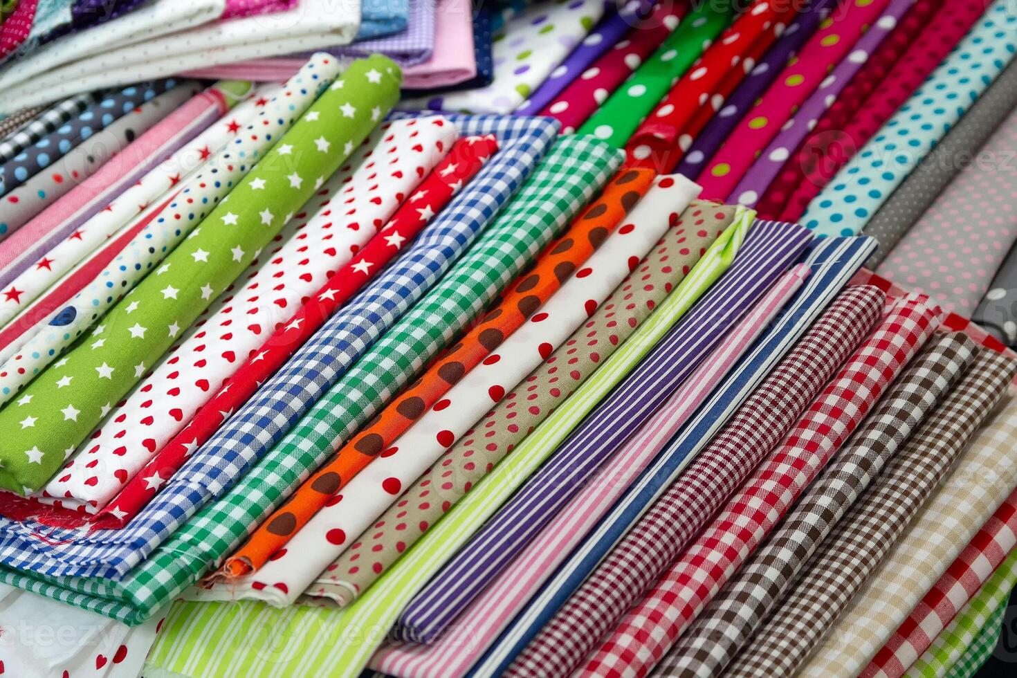 Multicolored textiles on the counter of the store photo