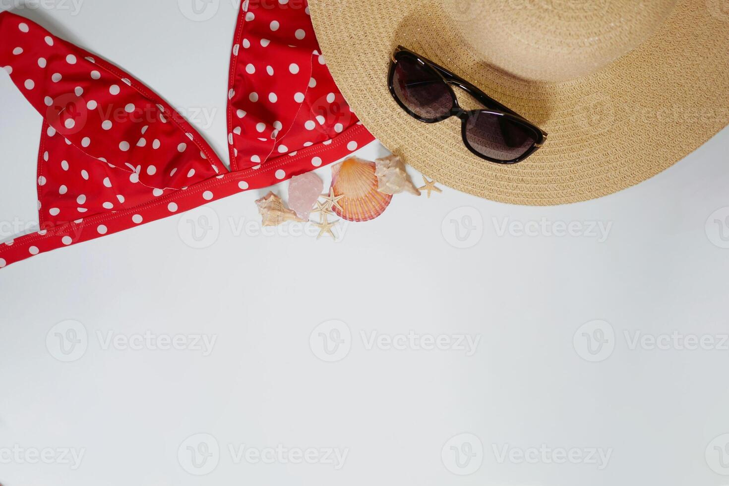 Summer travel vacation mood layout lifestyle spa wellness concept with accessories and copy space. Top view flat lay background, including straw hat, sunglasses, swimsuit, seashells and pebbles photo