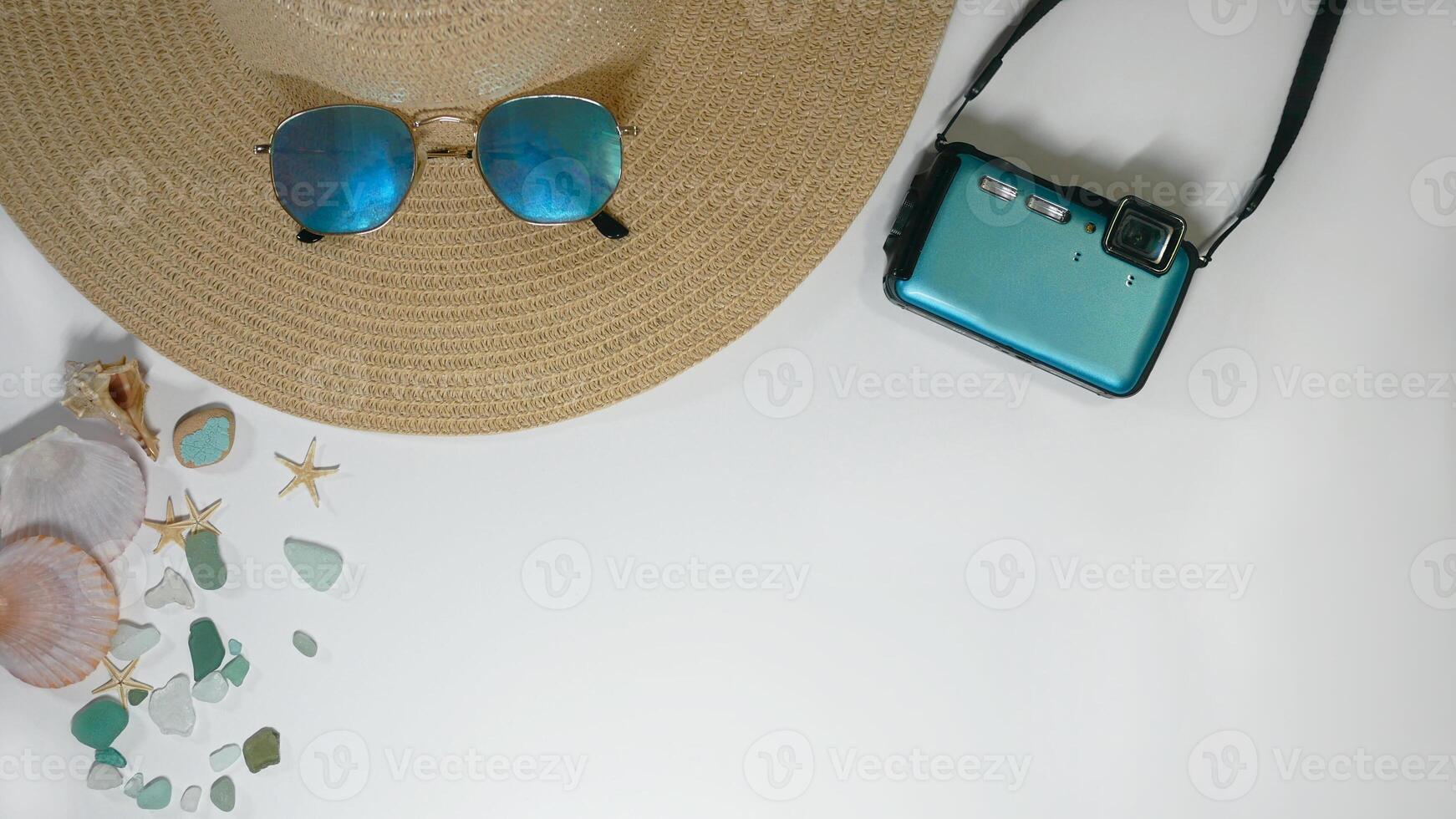 Summer travel vacation mood layout lifestyle spa or wellness concept with beach accessories and copy space. Top view flat lay background, including straw hat, sunglasses, photo camera