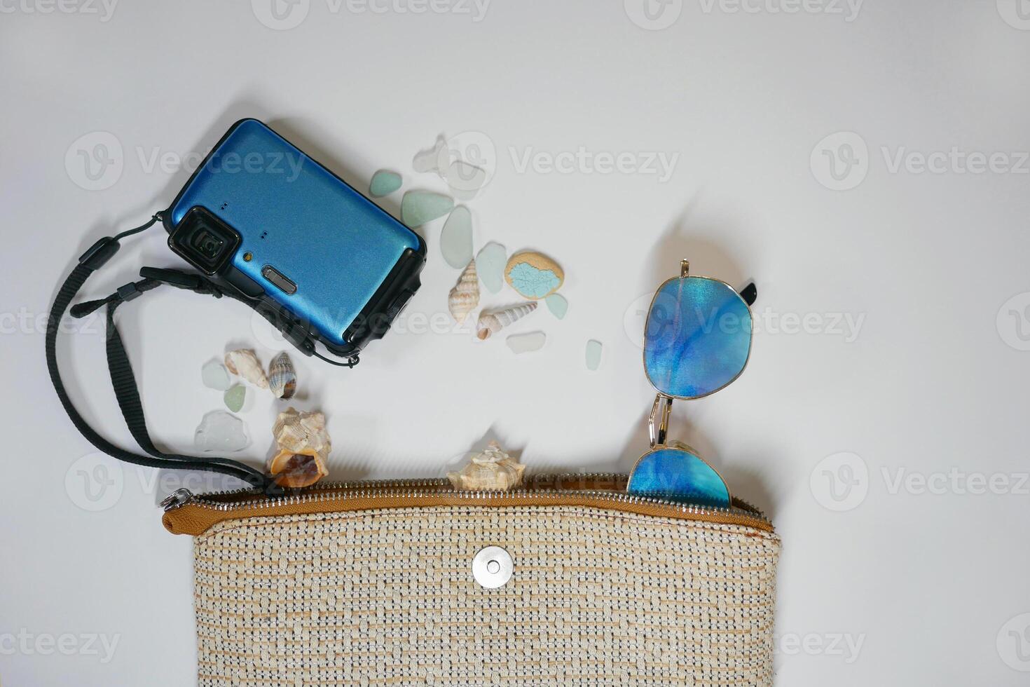 Travel vacation mood layout lifestyle spa or wellness concept with beach accessories and copy space. Top view flat lay background, including beach bag, sunglasses, photo camera