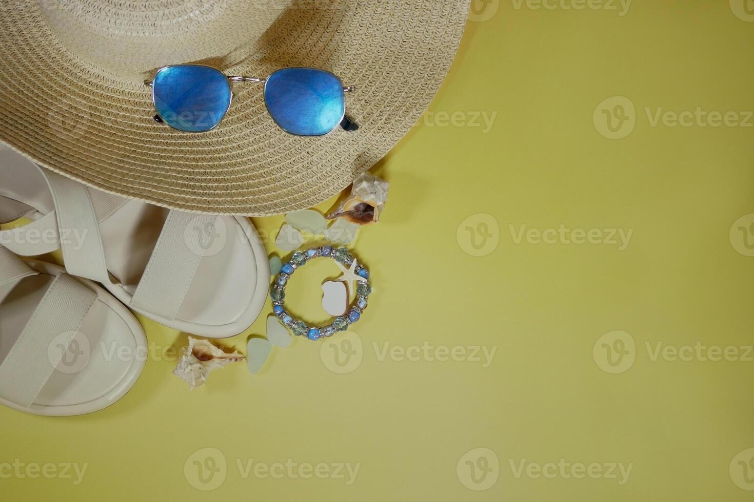 Summer travel vacation mood layout lifestyle spa wellness concept with beach accessories and copy space. Top view flat lay background, including straw hat, sunglasses, sandals, seashells photo