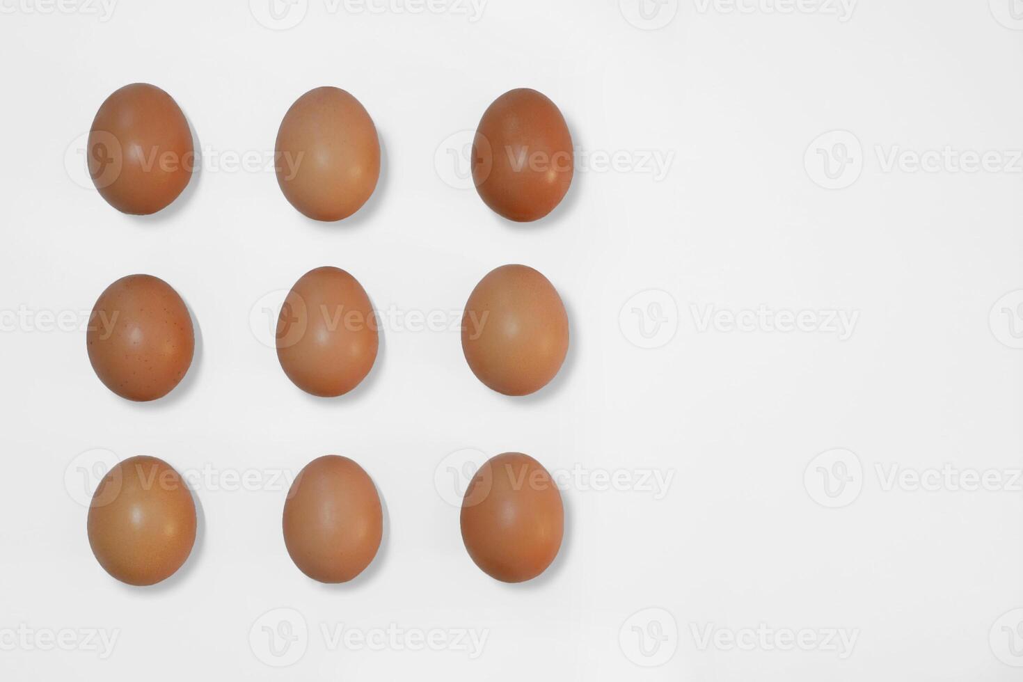 Raw brown chicken eggs on a white background with copy space photo