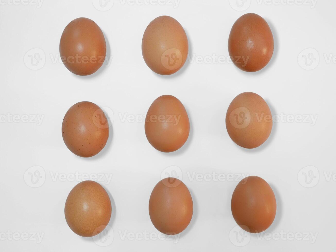 Raw brown chicken eggs on white background with copy space photo