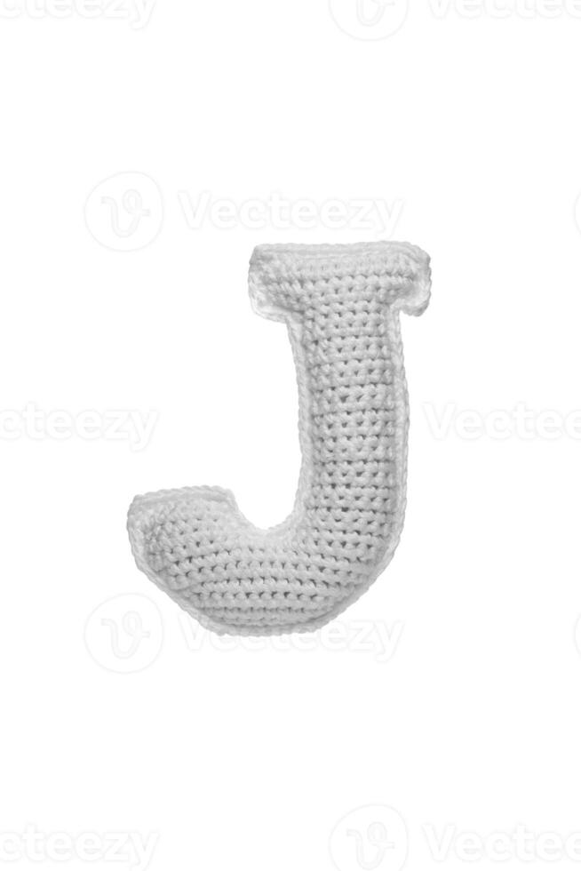 Handmade crocheted letter J in light grey yarn, isolated on white background photo