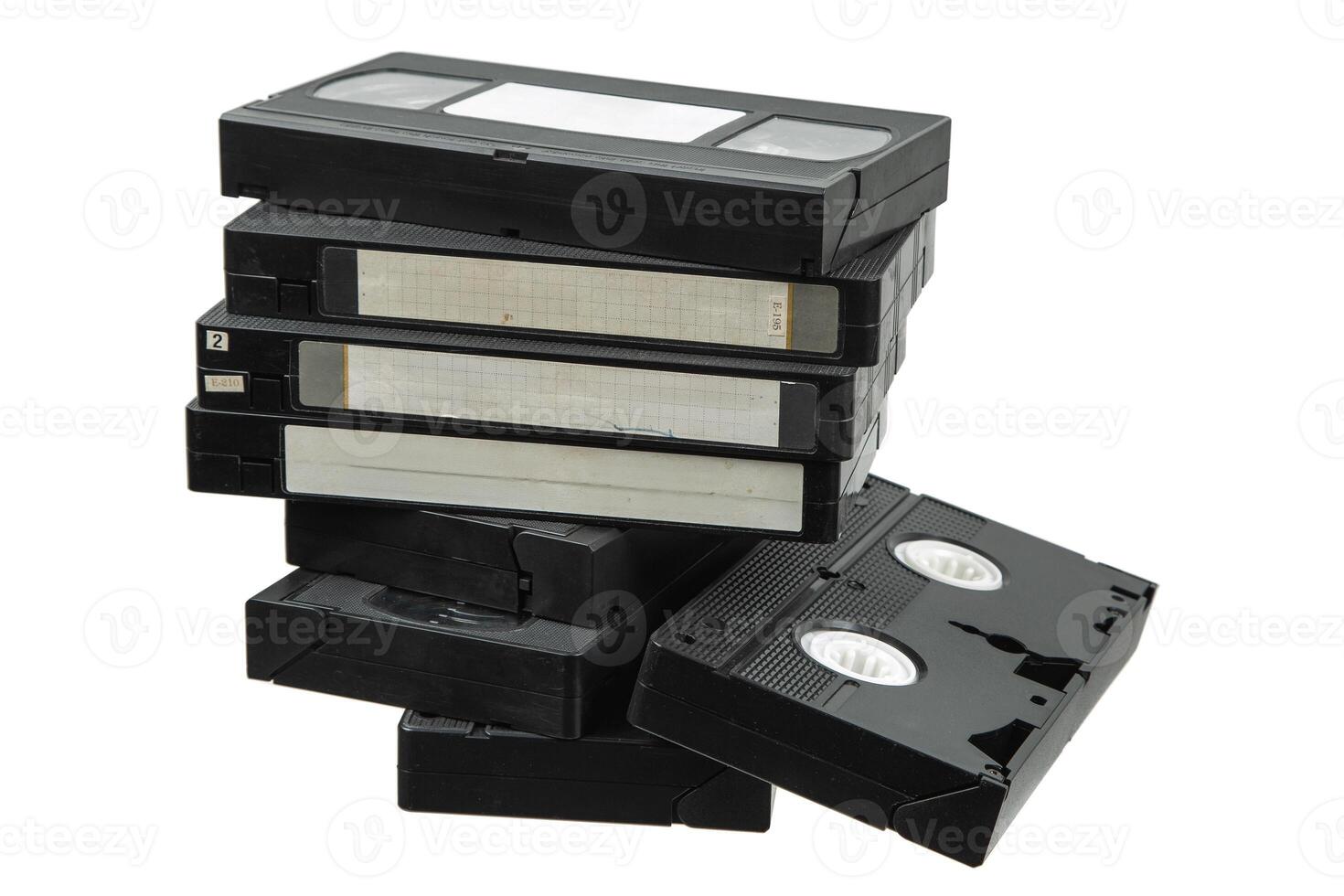 Pile of classic VHS tapes in black cases, nostalgic retro media storage collection photo