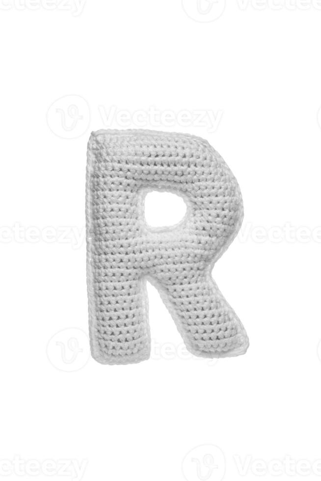 Handmade crocheted letter R in light grey yarn, isolated on white back photo