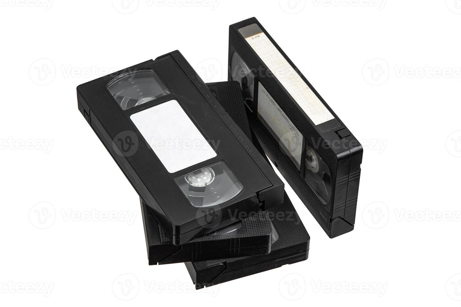 A group of classic VHS cassettes piled on top of each other, evoking retro charm. photo
