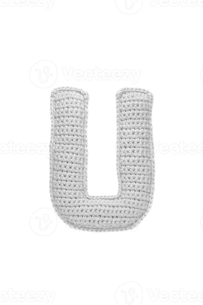 Handmade crocheted letter U in light grey yarn, isolated on white back photo