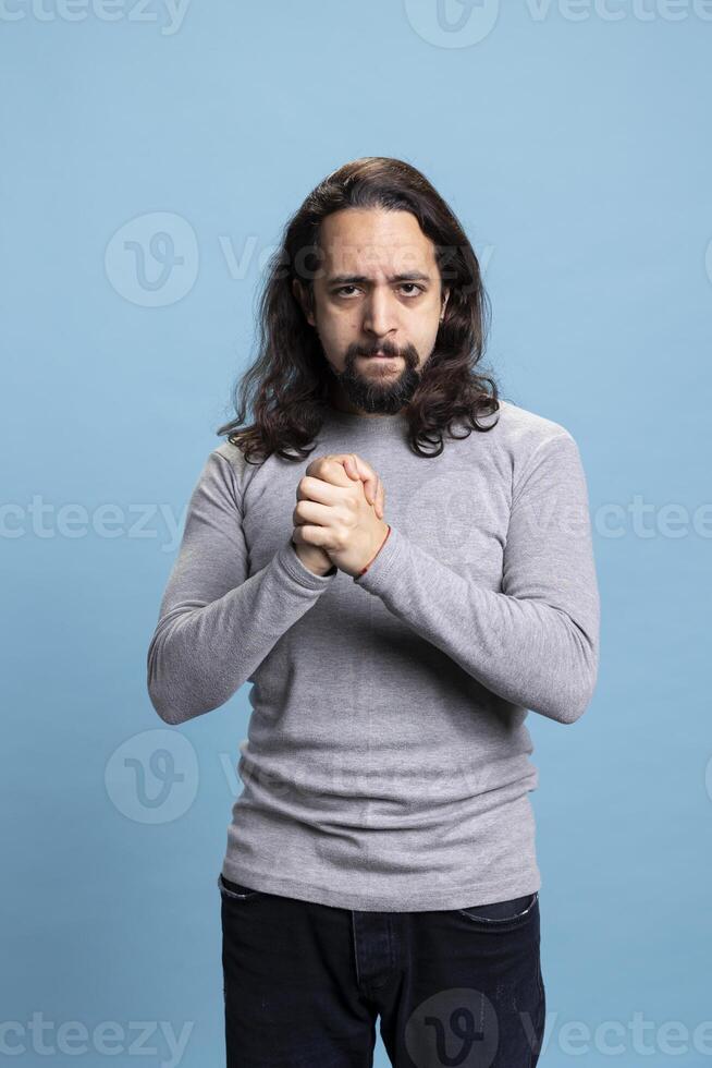 Confident serious person feeling enthusiastic about something on camera, being ecstatic with a vibrant ambitious attitude. Middle eastern guy being self assured and satisfied or pleased. photo