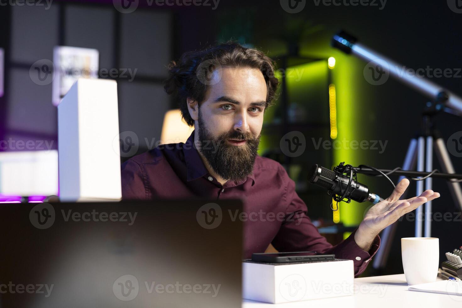 Tech guru filming technology review of newly launched cellphone, doing unboxing and presenting specifications to viewers. Content creator showing mobile phone box to subscribers photo