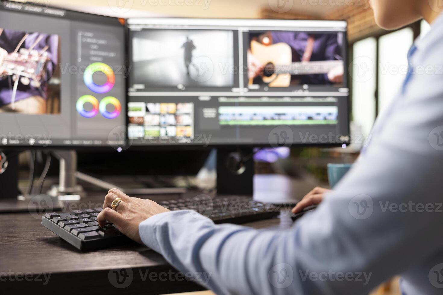 Closeup of editor with hand on keyboard, using advanced software to refine movie footage. Professional filmmaker working with multi monitor, adjusting film frames to improve cinematic quality. photo
