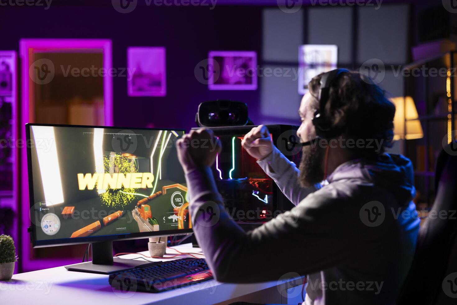 Esports player playing videogames in front of subscribers during livestream, celebrating after winning online match. Pro gamer streaming game for viewers, feeling happy after beating opponent photo