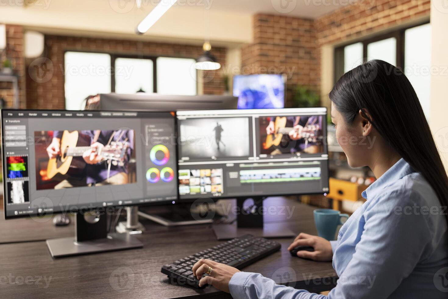 Focused female filmmaker sits at a workstation, carefully refining projects with editing software. Asian woman adjusting clips, processing audio, and enhancing footage with cinematic effects. photo