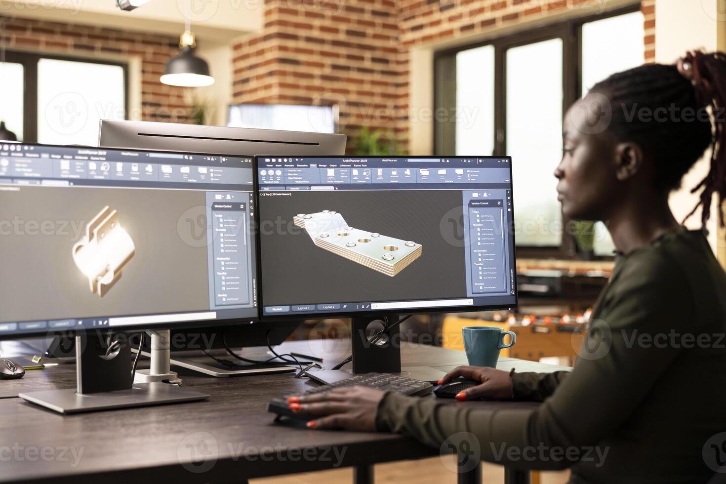 African american technical expert prototyping machinery and constructing engine models digitally. Black female engineer designing mechanical gears using CAD software in brick wall office. photo