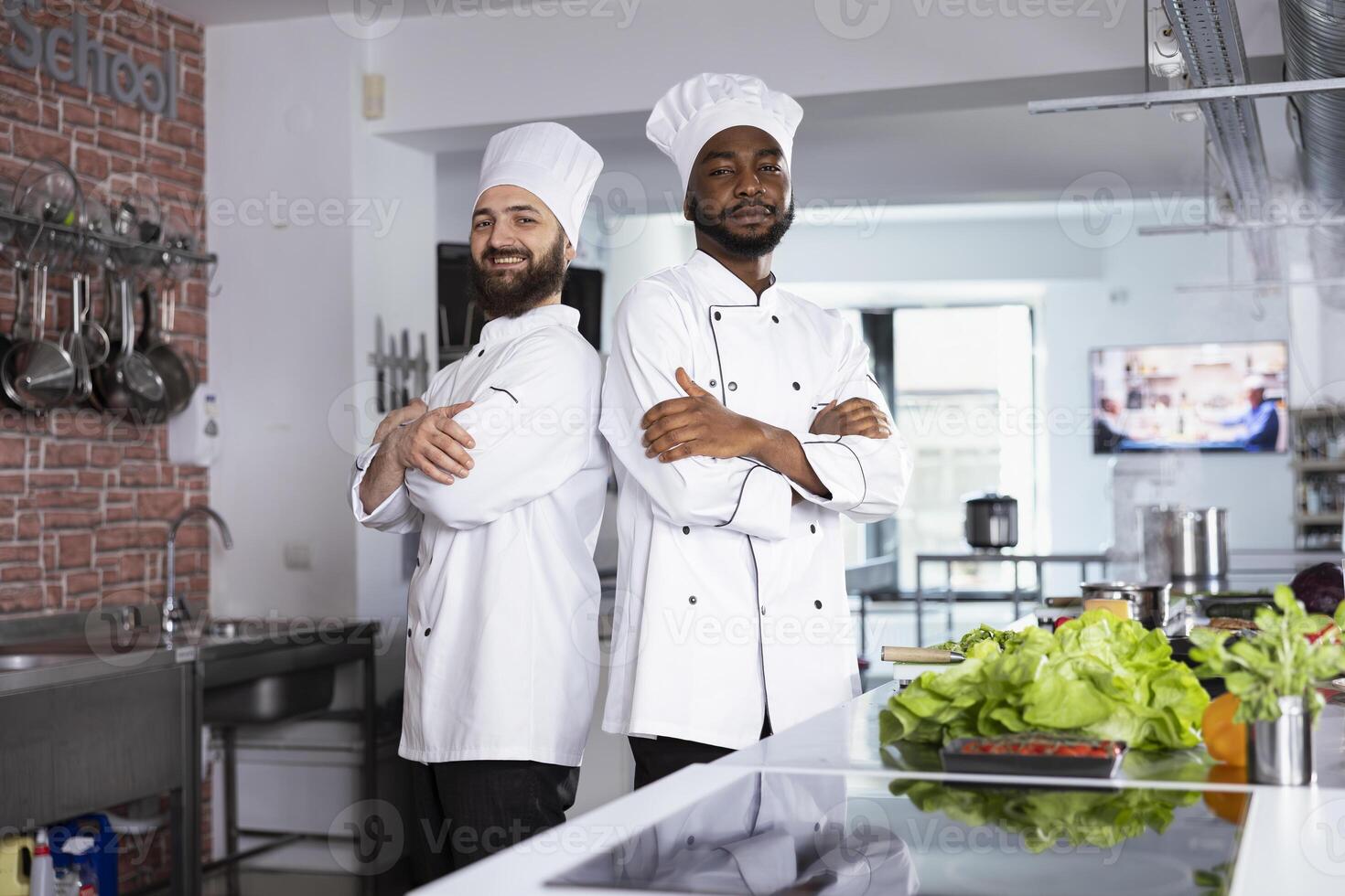 Diverse chefs in uniform preparing a delicious meal in a professional kitchen, preparing fresh ingredients to cook a gourmet dish on a stove. Using culinary tools to create a professional recipe. photo