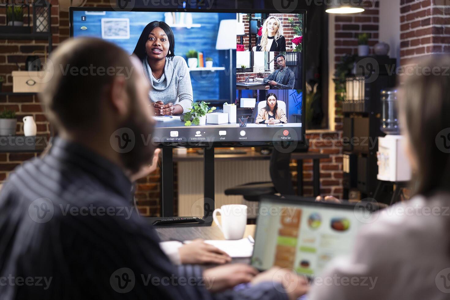 Professional businesswoman leading a remote team meeting to discuss marketing strategy and goals. Diverse professionals engage in virtual call to share ideas and review project timelines. photo