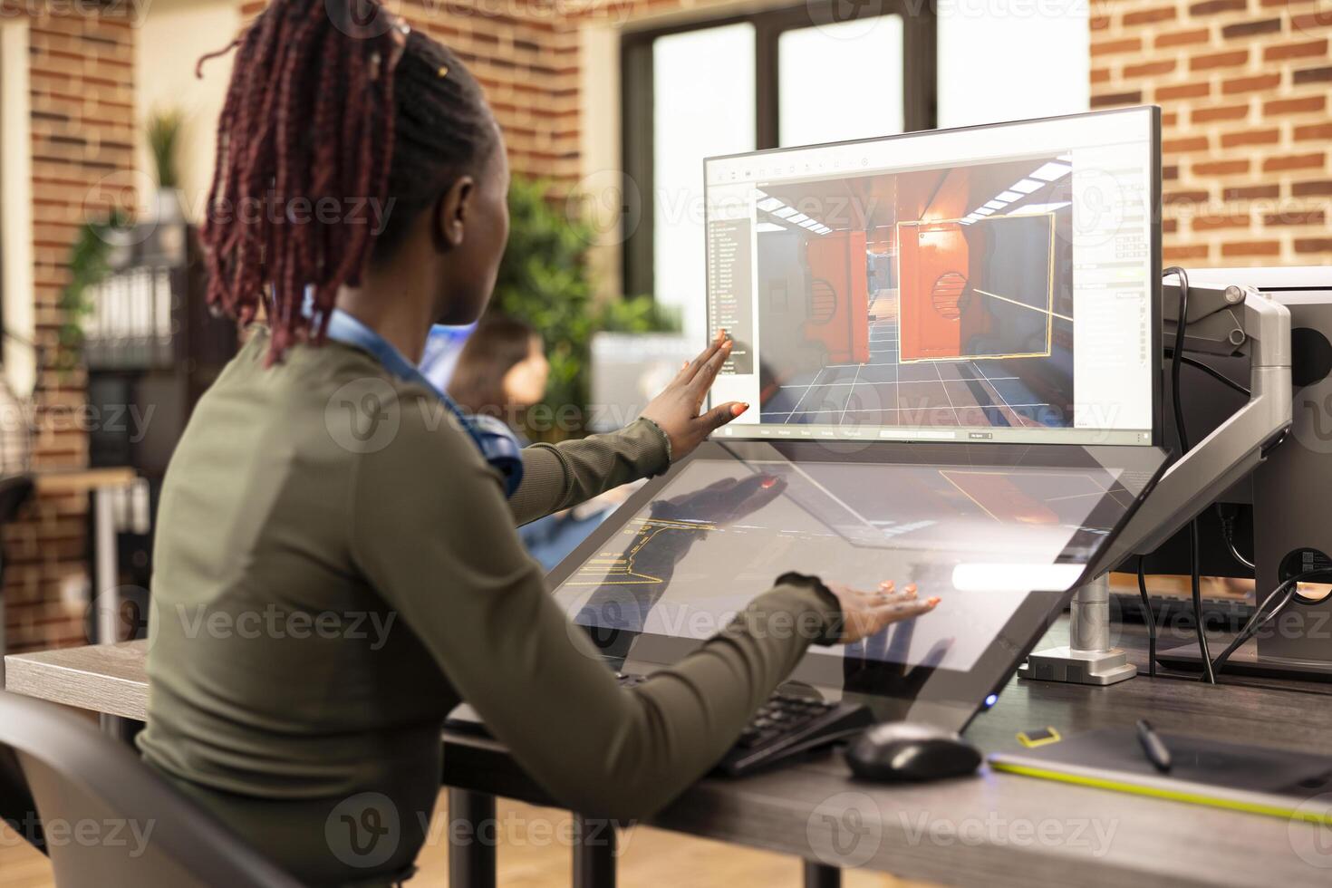 African American designer refining projects on digital monitors, enhancing visuals in modern creative workspace. Black woman focused on editing and 3D modeling, working across multiple screens. photo