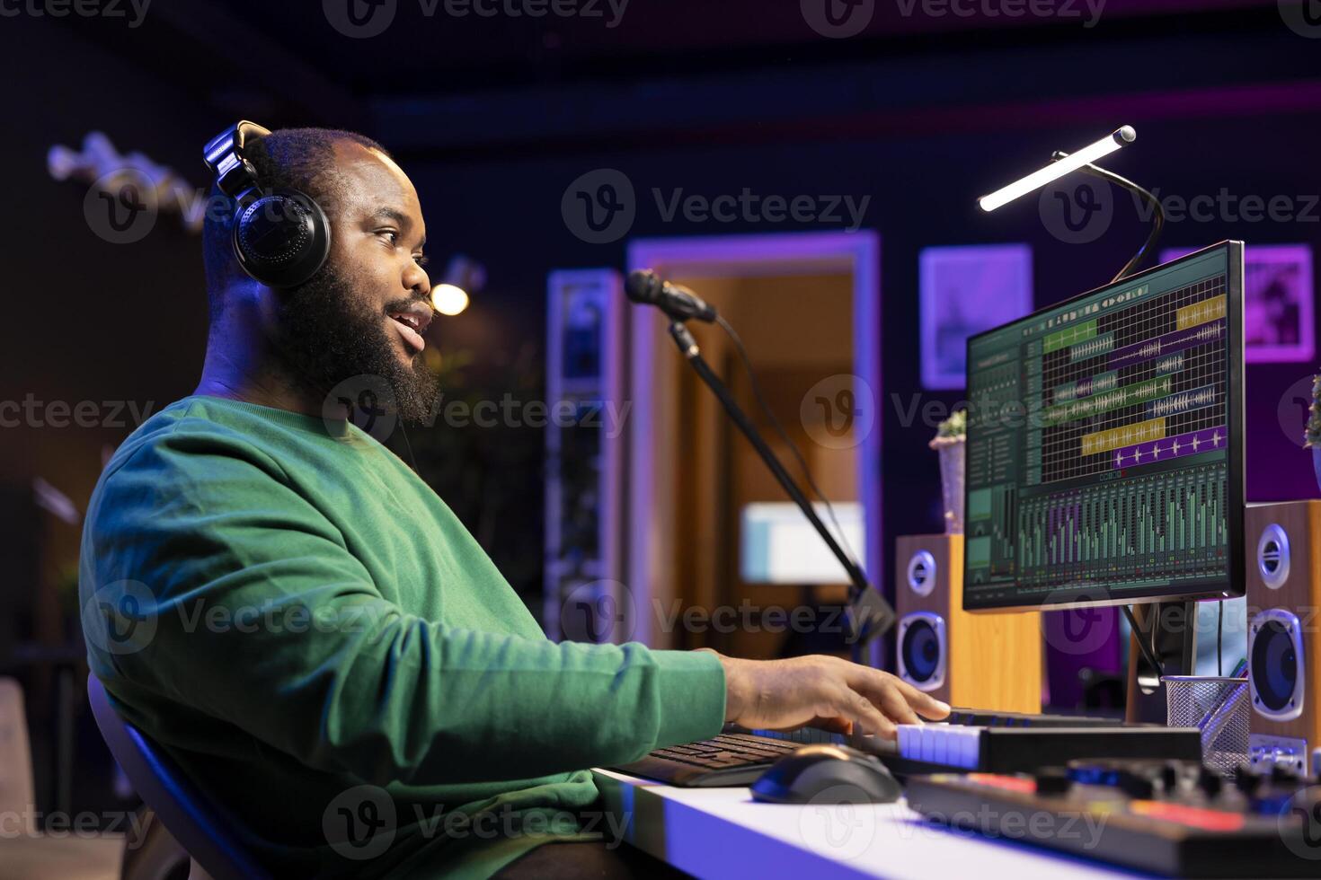 Artist playing electronic piano keyboard to record sounds and use mixing techniques, editing recordings in home studio. Musician songwriter operating on electronic synthesizer gear. photo