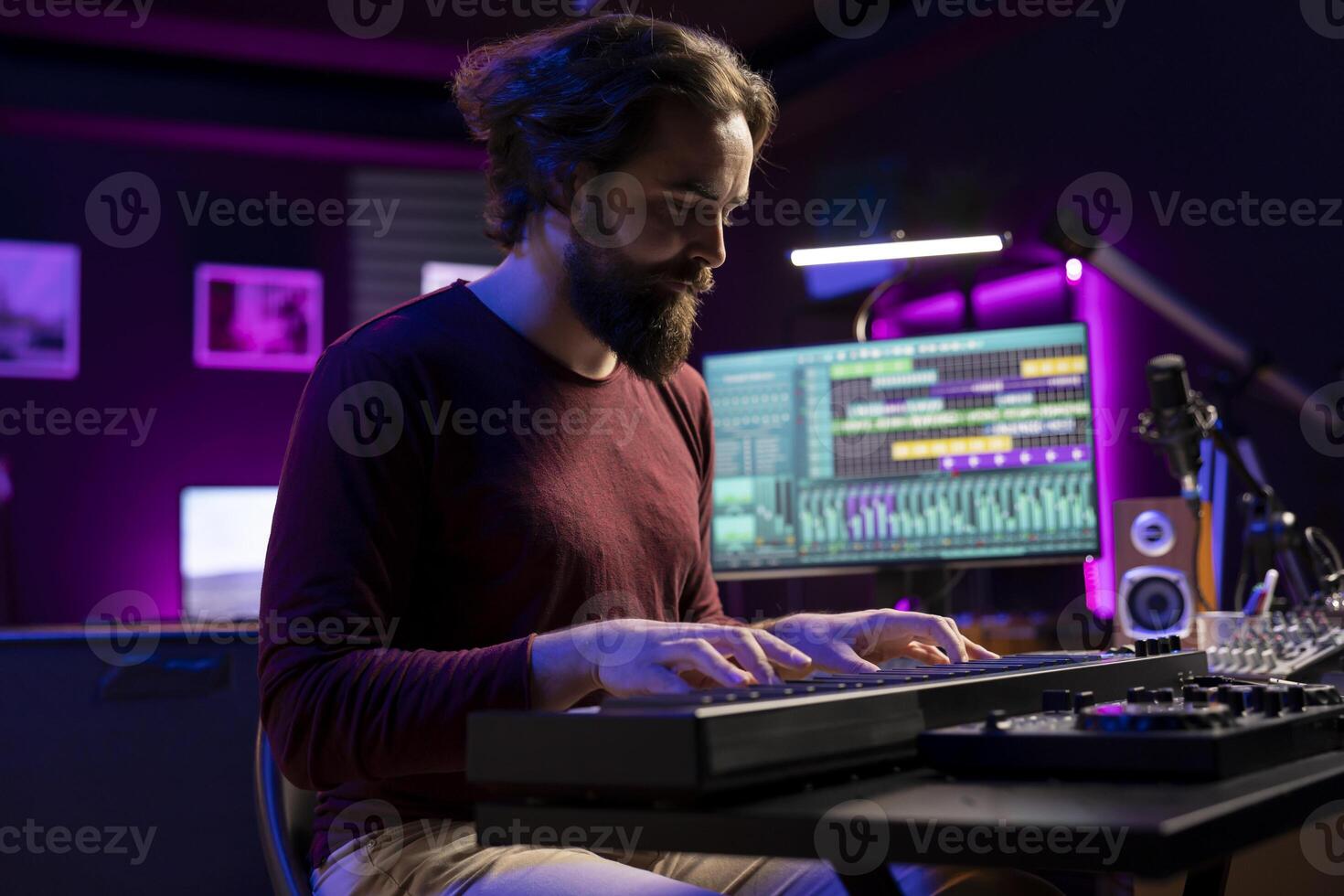 Skilled artist creating new music on electronic midi controller in home studio, recording songs with mixing console and daw software. Singer playing piano keyboard notes, synthesizer tool. photo