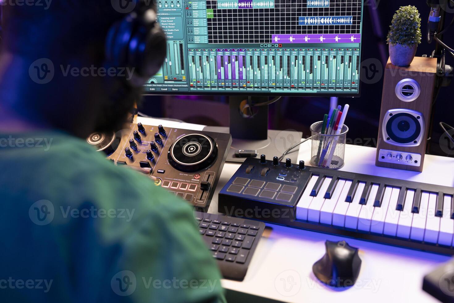 Sound engineer mixing and mastering new music on console and daw software in home studio, twisting pre amp knobs. Talented composer producing songs for the industry. Close up. photo