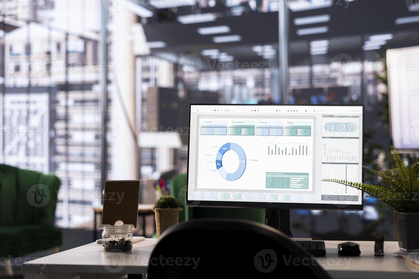 Modern office desk displays financial data on a monitor. The detailed analytics and graphs highlight business strategy and success, supported by data management and analysis tools. photo
