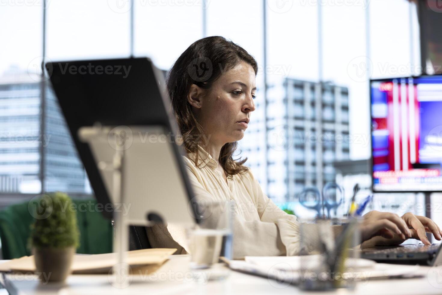 Empowered ambitious female CEO working on career development strategy, multitasking in order to increase enterprise profit. Decision making leadership skills for productivity and work ethic. photo