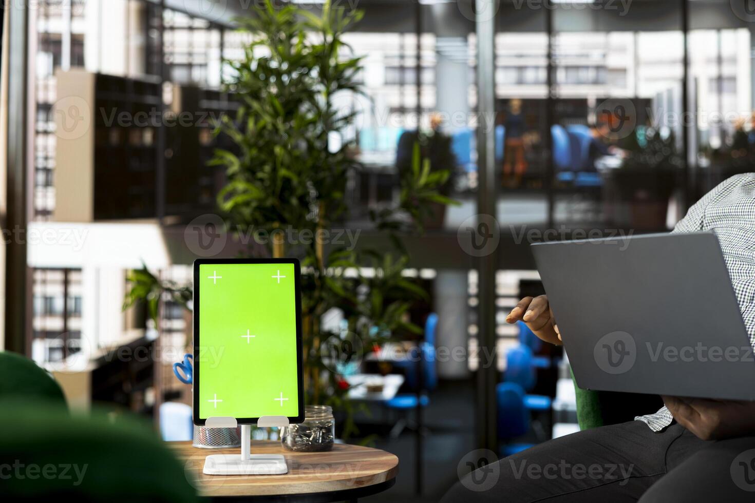 Green screen tablet and laptop used by staff member preparing for business meeting. Mockup device next to office clerk using notebook in startup to do research analysis, reading documents online photo