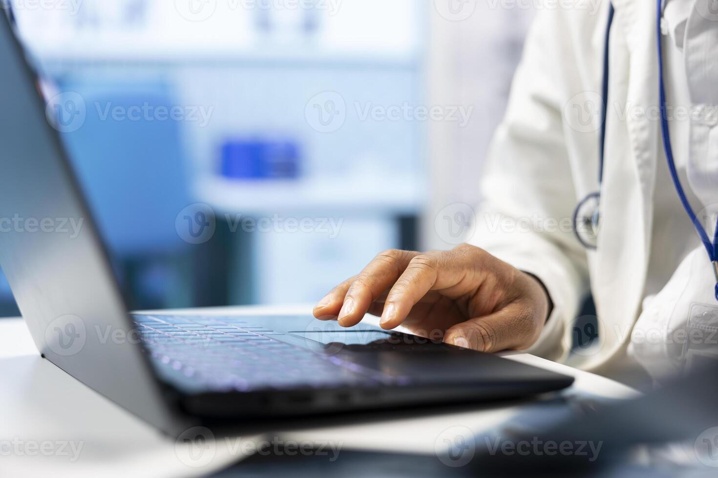 Licensed specialist examining healthcare records on laptop and x ray scan results, finding the right diagnostic at a private clinic. Doctor consulting hospital archives for treatment plan. Close up. photo