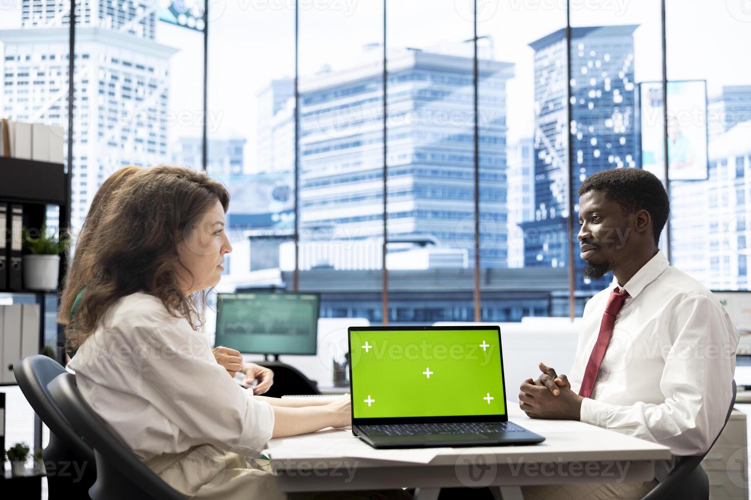 Team of HR experts negotiating job offers and salary packages with candidate, using green screen laptop. Colleagues analyzing applicant resume and cover letter, using mockup notebook photo