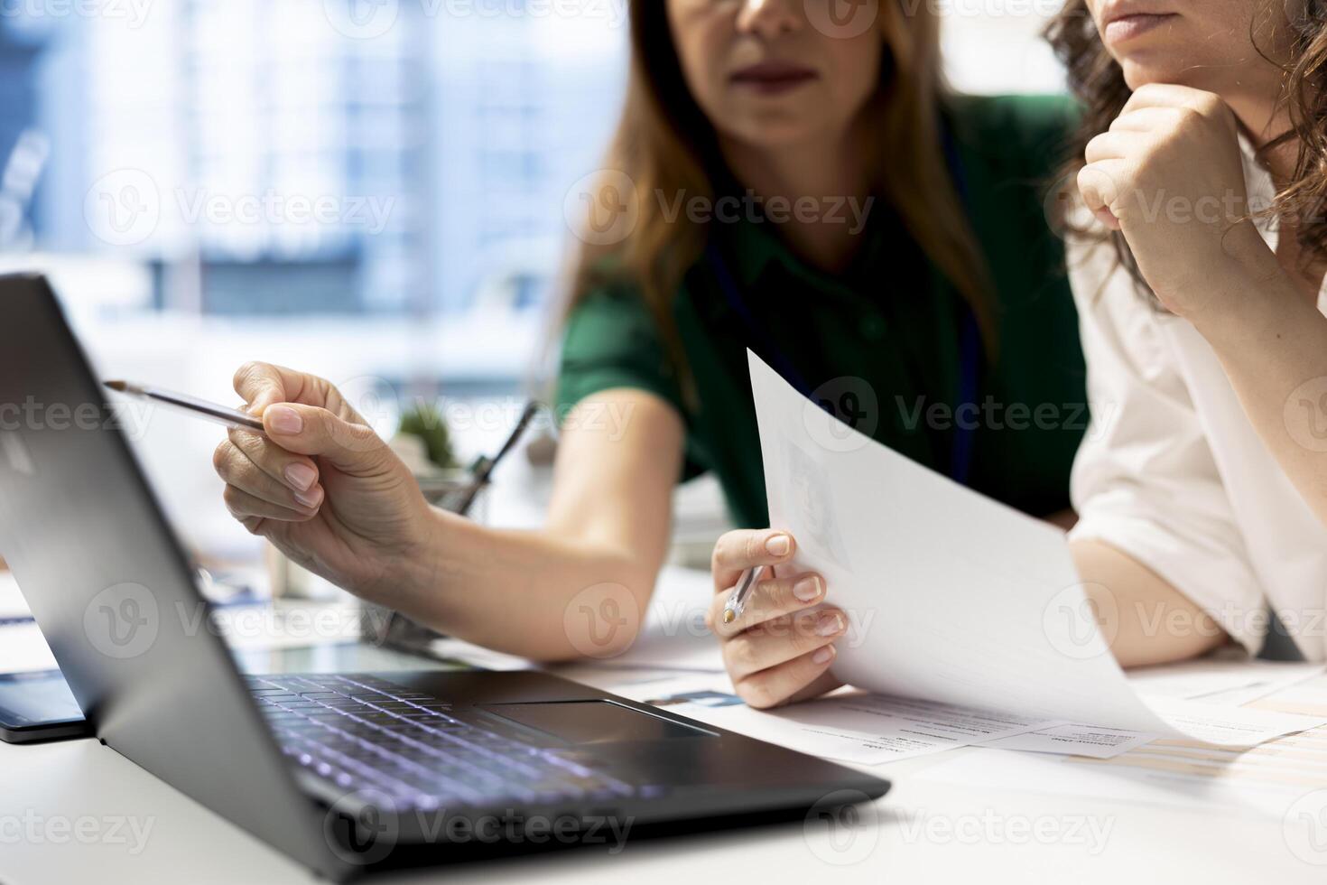 HR coworkers using laptop to do preemployment assessments and background checks to potential job applicants. Headhunters use notebook to implement recruiting strategies to attract qualified candidates photo