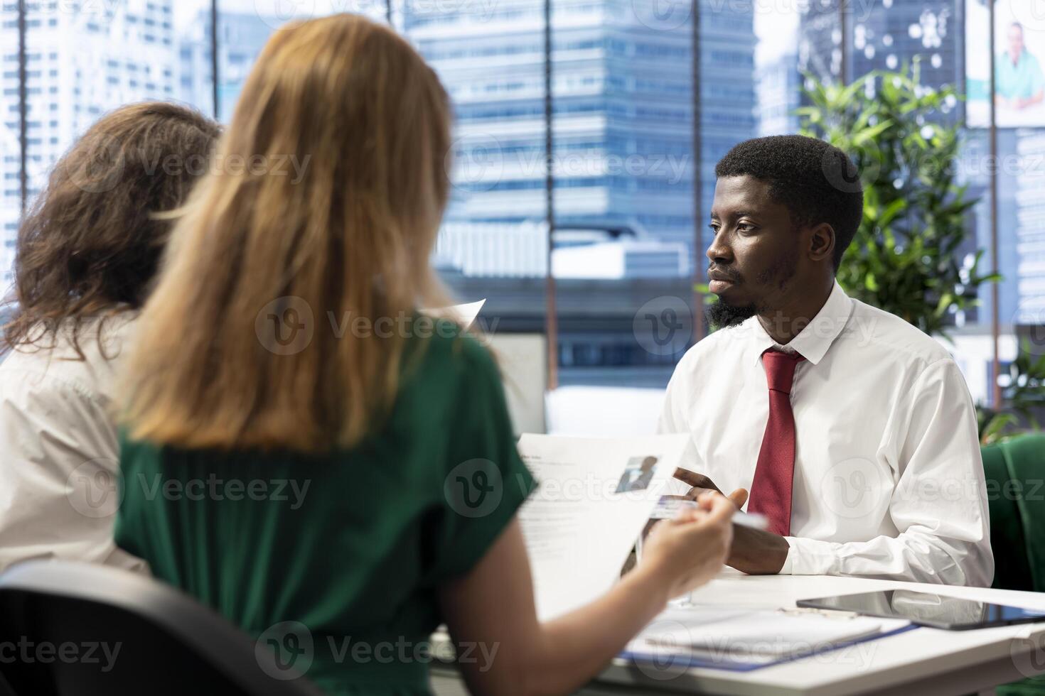 Team of headhunters tasked with hiring best talent to fill open company position, interviewing person. HR coworkers hired to assess skills and qualifications of candidate, doing meeting in office photo