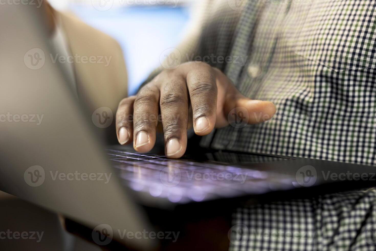 Office clerk reading company documents on laptop, checking progress on customer commissioned project tasks. Staff member comparing key data statistics on notebook after business audit photo