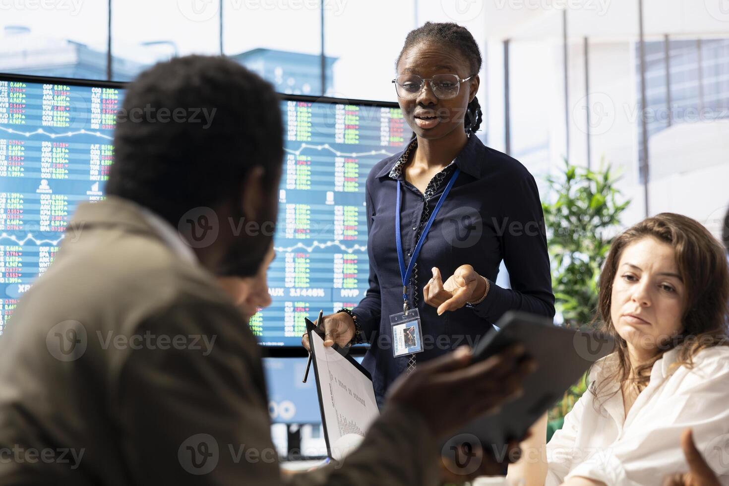 Business professional staff gather to review project development progress, analyzing detailed reports and statistics on interactive board to ensure strategic objectives. Diverse work team in meeting. photo