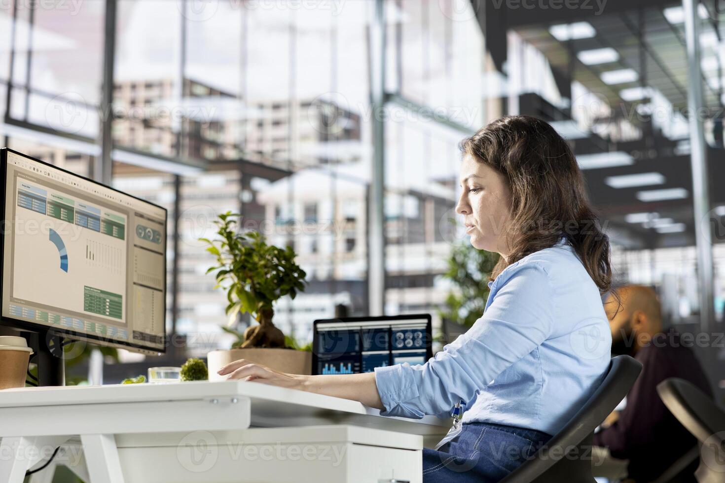 General manager engaged in budget analysis and strategy development at the office, achieving objectives for enterprise growth. Woman managing analytics to accomplish business goals. photo