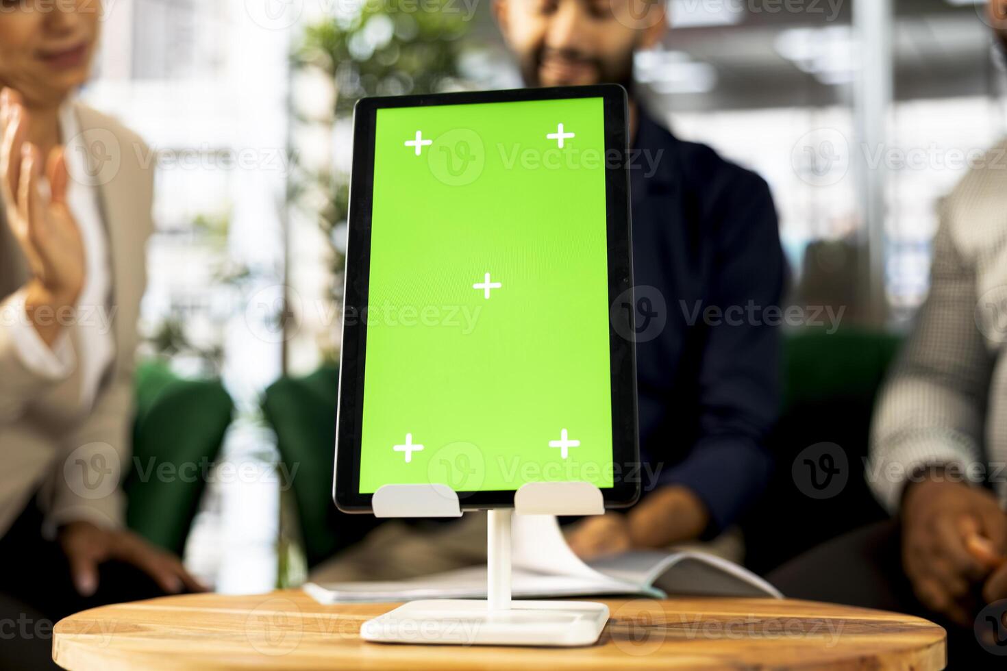 Focus on isolated screen tablet used by employees in blurry background preparing for business meeting. Close up of chroma key device used by people doing research analysis for startup organization photo
