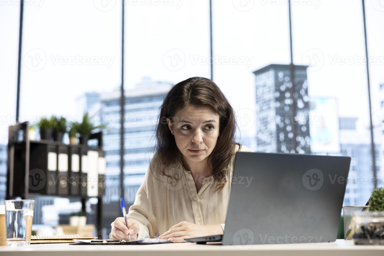 Entrepreneur with authority and executive power signing work contracts, solving her daily tasks of authorizing different requests from department employees. Jurisprudence paperwork. photo