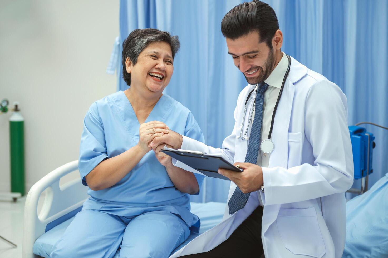 A doctor is talking to a woman in a hospital bed photo