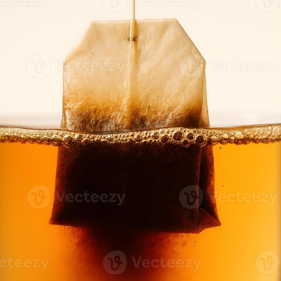 Close Up of Tea Bag Brewing in Hot Water with Bubbles Rising for Relaxing Beverage and Refreshing Drink Concept photo