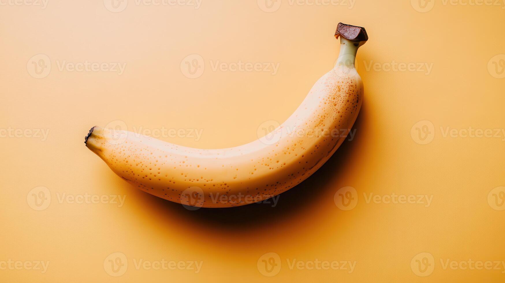 A banana is shown on a yellow background photo