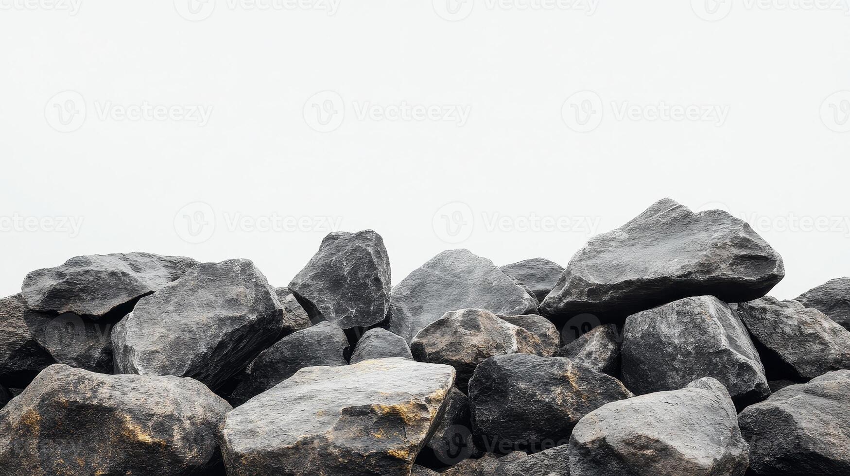Pile of rough stones at a construction site under overcast sky during daytime in an urban area photo