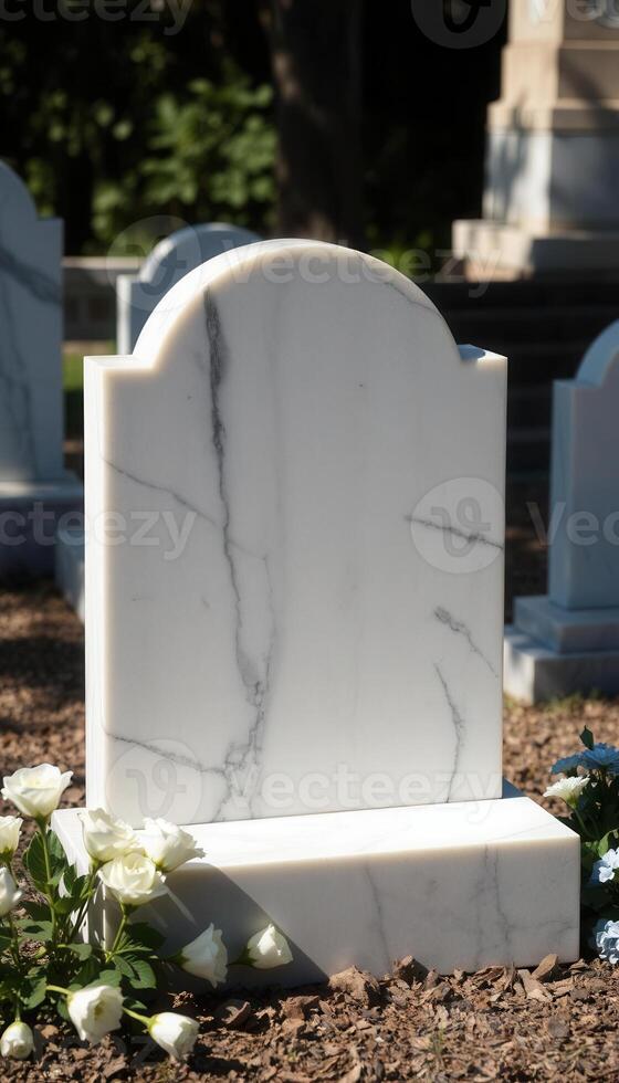 A white marble tombstone with flowers in front of it photo