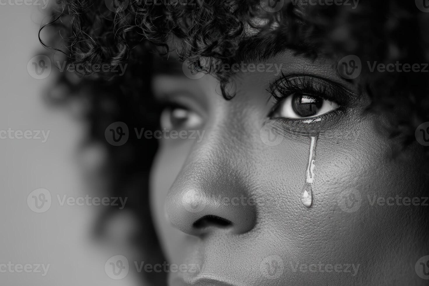 Emotional expression captured in close-up portrait of a woman with tears in her eyes photo