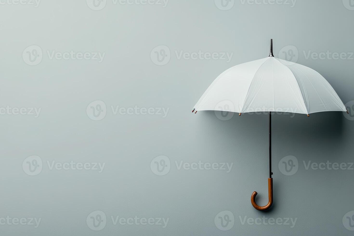 White umbrella hanging against a plain gray background showcasing minimalistic design photo