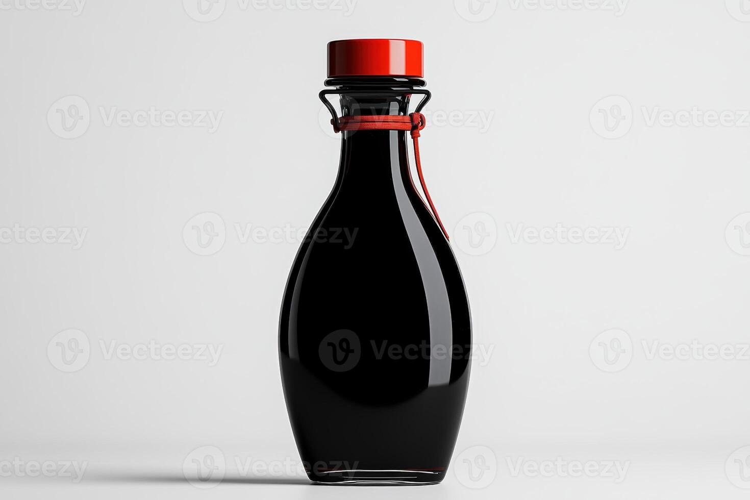 Elegant glass bottle with a red cap filled with dark liquid, perfect for culinary use photo