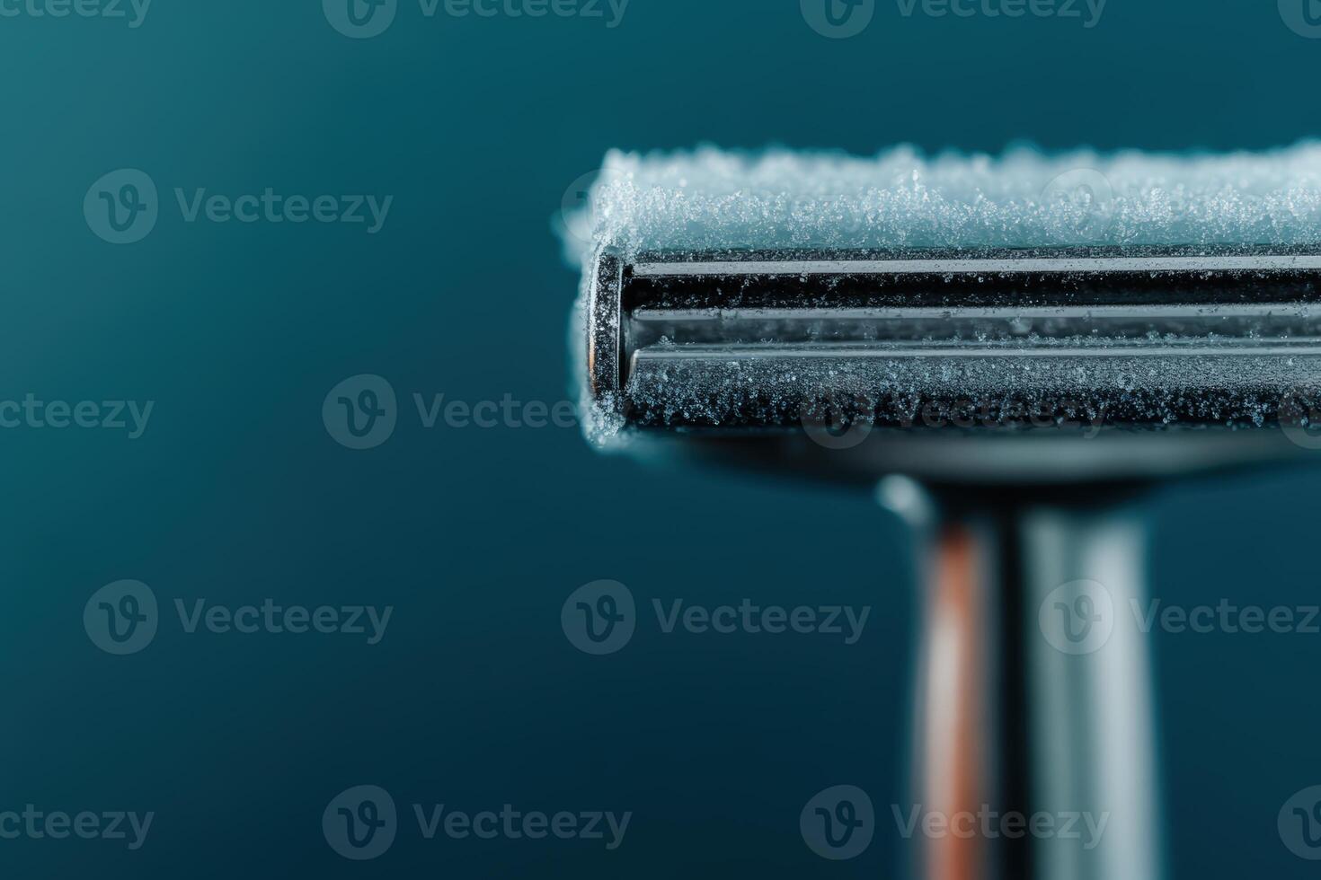 Razor covered in frost resting against a blue background in a cool atmosphere photo