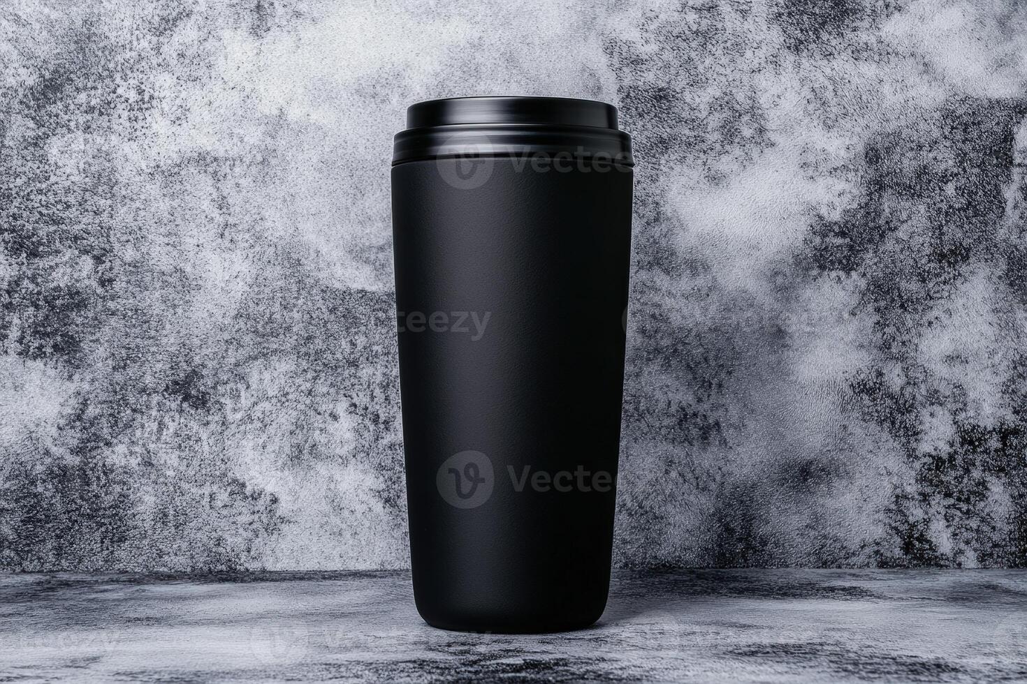 Stylish black travel mug on a textured grey background for on-the-go sipping needs photo
